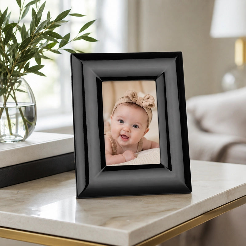 Black 5x7 photo frame with portrait picture displayed on marble surface