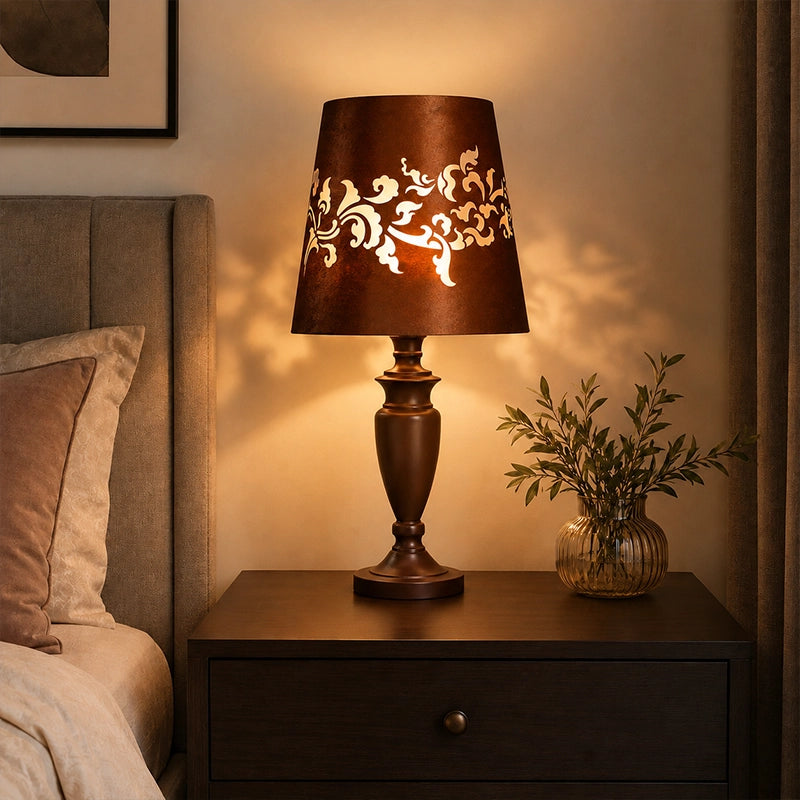 Brown bedside table lamp with patterned shade on wooden nightstand