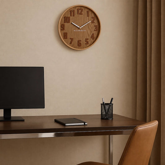 Brown round wall clock above home office desk with monitor