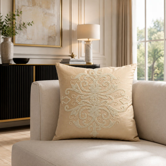Natural beige decorative cushion with textured embroidered pattern on a cream sofa