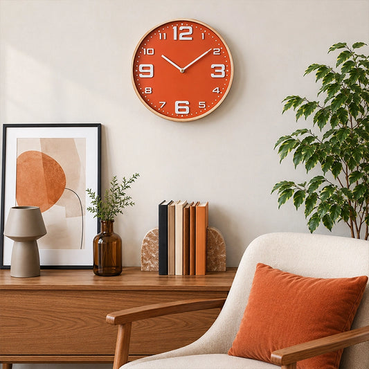Orange wall clock with large white numbers above wooden sideboard