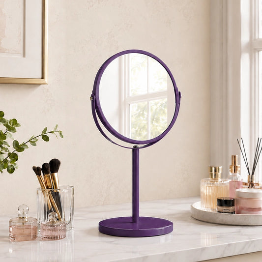 Purple round swivel mirror on bathroom vanity with toiletries