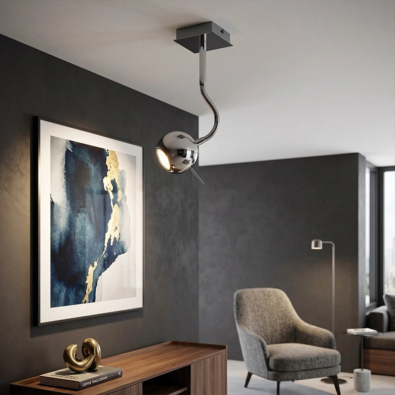 Silver metal ceiling light with curved arm and globe shade in modern living room interior