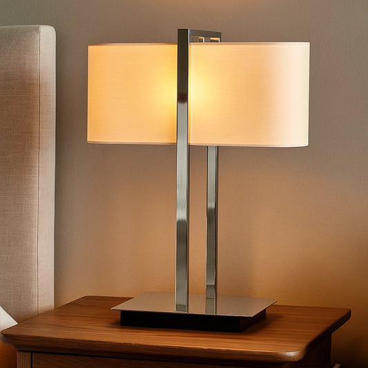 Silver table lamp with rectangular white shade on wooden side table