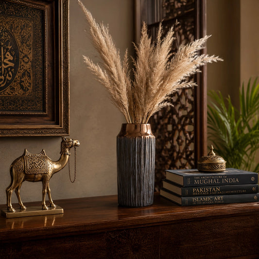 Small grey decorative vase with tall dried pampas grass styled on a wooden console table