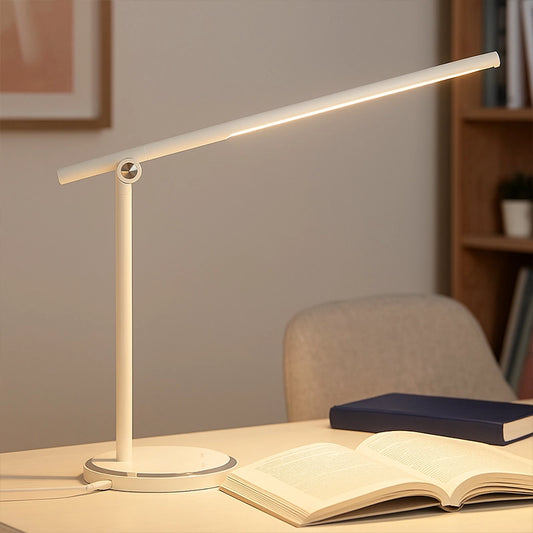 White touch lamp with slim LED bar on desk beside open book