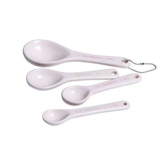 White ceramic measuring spoons set of 4 with hanging ring on white background