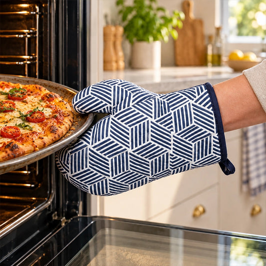 White and blue geometric diamond pattern single oven mitt used to pull a pizza from the oven