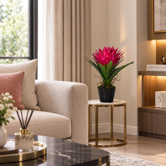 Artificial pink tropical plant in a decorative pot styled in a bright Scandinavian living room