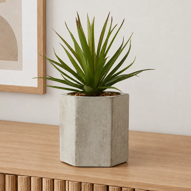 Artificial sword grass plant in a cement pot styled in a clean minimal modern interior