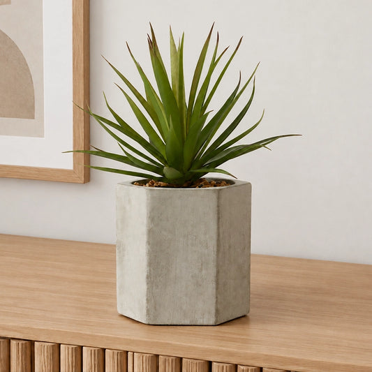Artificial sword grass plant in a cement pot styled in a clean minimal modern interior