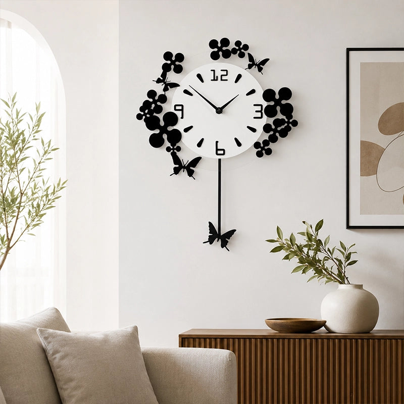 Black and white floral wall clock above sofa in neutral living room