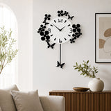 Black and white floral wall clock above sofa in neutral living room