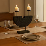 Black double candle holder with two pillar candles styled as a dining table centrepiece