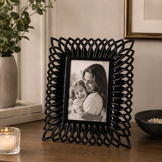 Black photo frame with textured border displaying portrait photograph
