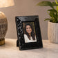 Black table photo frame with decorative finish beside home decor