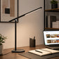 Black touch desk lamp with slim LED bar beside laptop and notebook
