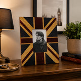 Black and gold 5x7 photo frame with geometric pattern on wooden table