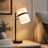 Black and white table lamp on side table with warm light