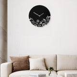 Black wall clock with white floral pattern above sofa in living room