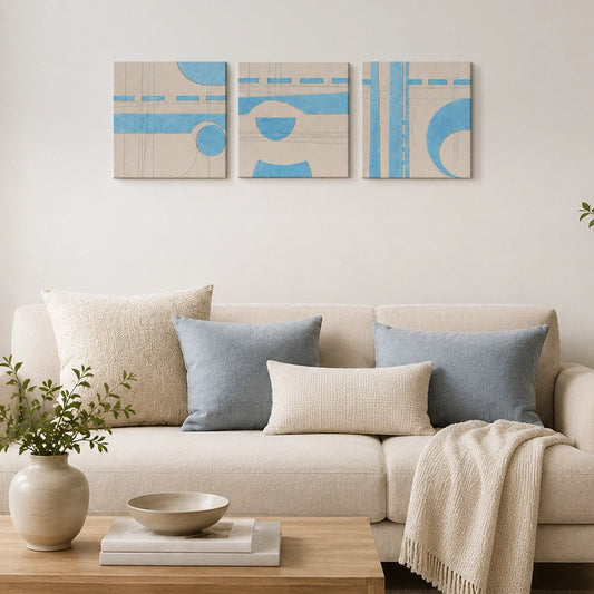 Blue and cream geometric wall art set with modern abstract shapes displayed above a living room sofa