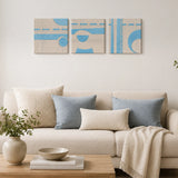 Blue and cream geometric wall art set with modern abstract shapes displayed above a living room sofa