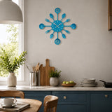 Blue cutlery wall clock with spoon and fork design above kitchen counter