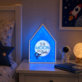 Blue moon and stars night light on bedside table in kids room