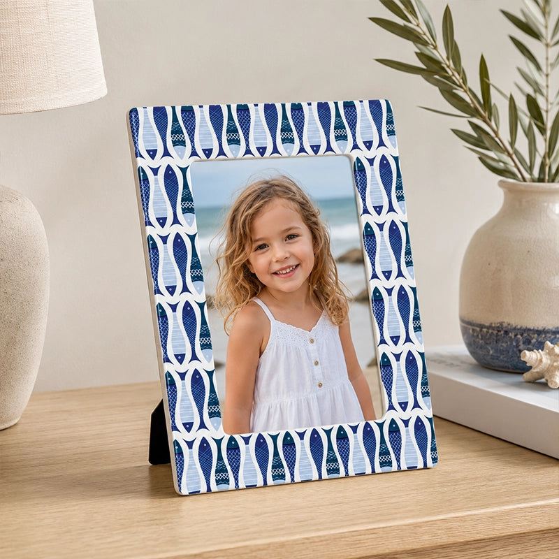 Blue decorative photo frame with geometric border on tabletop