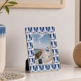 Blue photo frame with patterned border displaying landscape photograph