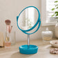 Blue plastic swivel table mirror on vanity with makeup brushes