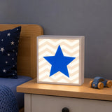 Blue star LED light box on bedside table in children’s bedroom