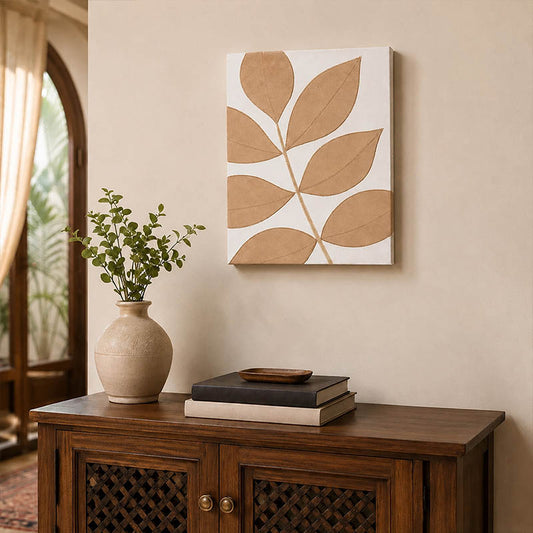 Beige and white botanical wall art with stylised leaf design displayed above a wooden console table