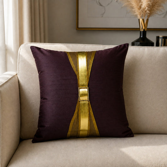 Brown decorative cushion with metallic gold centre panel styled on a cream sofa