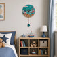 Bright wall clock above kids storage shelves with toys and books