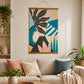 Colourful abstract canvas wall art with bold botanical and geometric shapes displayed above a neutral sofa