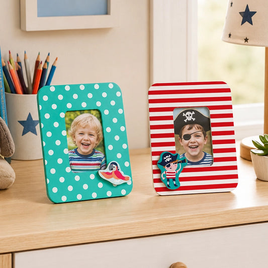 Colourful kids photo frame set with polka dot and pirate designs on wooden shelf