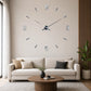 DIY mirrored wall clock with silver numbers above living room sofa