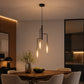 Modern gold and black pendant light over wooden dining table 