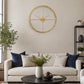 Gold finish metal wall clock above sofa with neutral living room decor