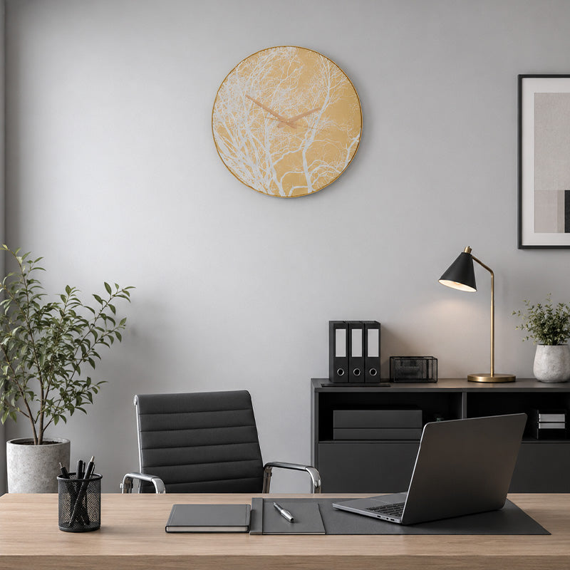 Gold finish plastic wall clock above home office desk and black chair