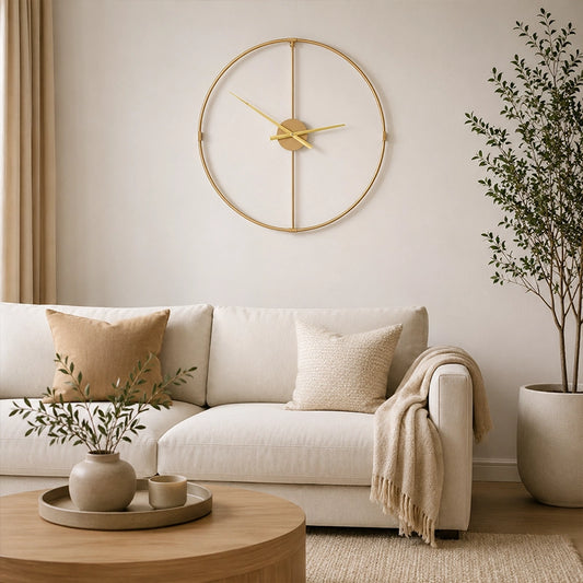 Gold metal wall clock with open face above sofa and round coffee table