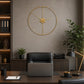 Gold metal wall clock above sofa in bright neutral living room