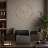 Gold metal wall clock above sofa in bright neutral living room