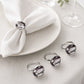Grey diamante napkin rings on white folded napkins in an elegant table setting
