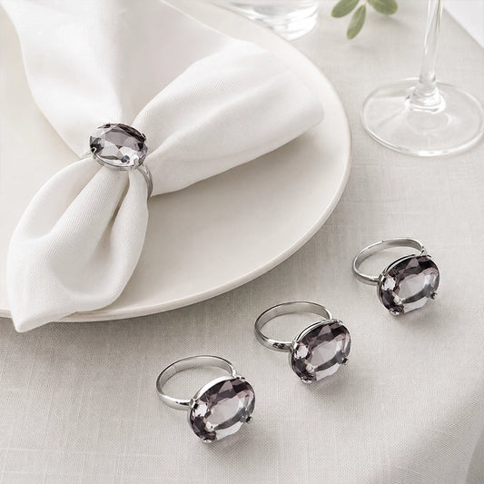 Grey diamante napkin rings on white folded napkins in an elegant table setting