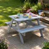 Grey children’s picnic table and bench set with plates in garden patio