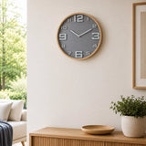 Grey wall clock with large numbers above wooden side table in living room