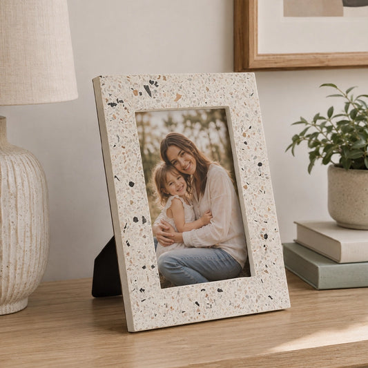 Grey picture frame with textured border displaying family photograph