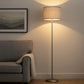 Grey shade floor lamp beside armchair in modern living room